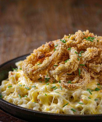 German Kaesespaetzle in a cast-iron skillet with melted cheese and crisp fried onions on top